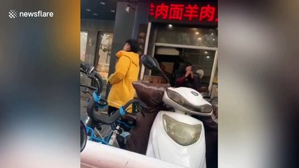 Chinese restaurant worker throws bone back into pan to cook after eating the meat off it