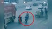 Quick-thinking biker narrowly avoids being run over by truck after being knocked over by another scooter in China