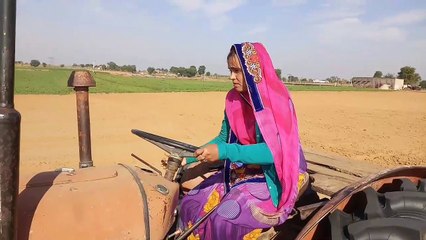 Village lady driver, driving Massey tractor