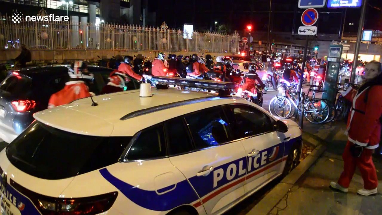 Annual charity event sees hundreds of bikers ride around Paris dressed as Santa Claus