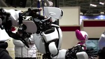 Japanese companies exhibit robots to help care for a rapidly aging society