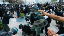 Police gun drawn as Hong Kong rally for China’s Uygurs descends into chaos