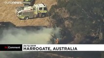 Australian firefighters tackle bushfires on Christmas Day as temperatures ease