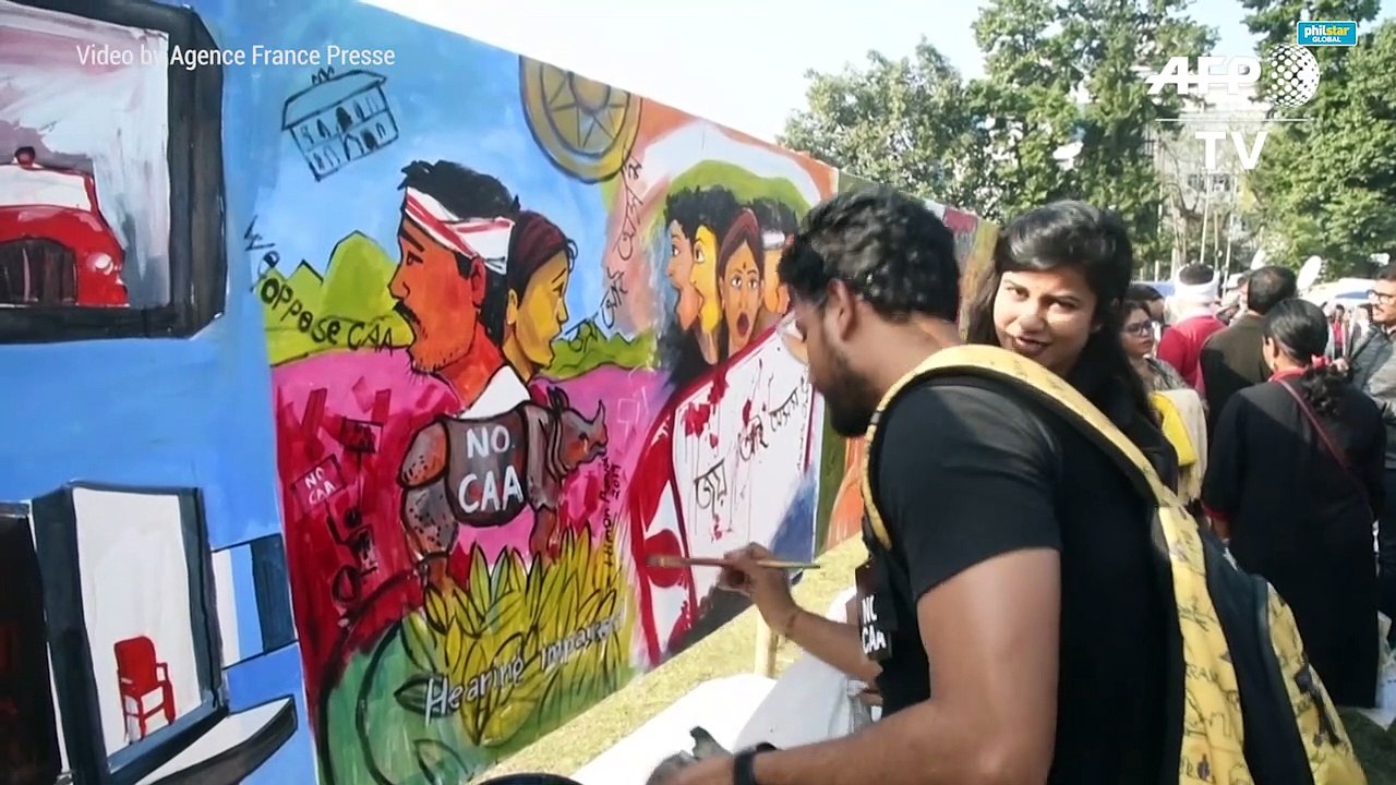 Indian protesters paint angry messages against new law