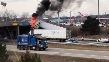 Truck Catches Fire after Colliding with Overpass