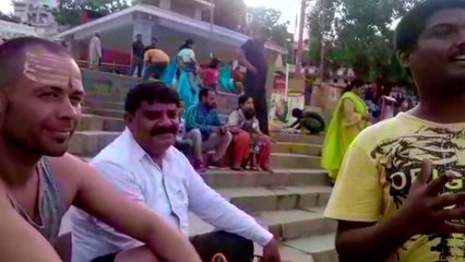 Boy introducing tourists about the holy ground of Varanasi in English