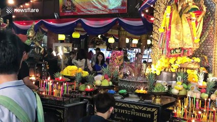 Worshippers whisper New Year Wishes into mouse's ear in Thailand