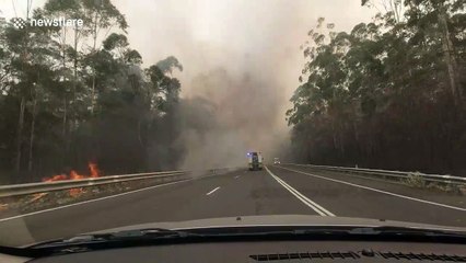 Convoy of fire engines drive through smoke filled highway to deliver supplies in New South Wales