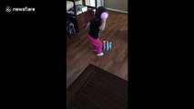 Little girl has unique way of knocking down bowling pins