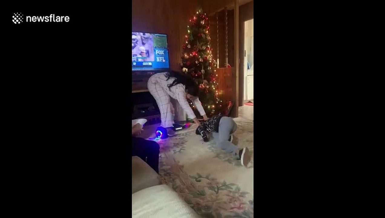 Hilarious Christmas moment when Arizona woman grabs on to her nephew to prevent herself from falling off a hoverboard