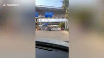 Chinese motorist shouts to stop woman after her car catches fire on road