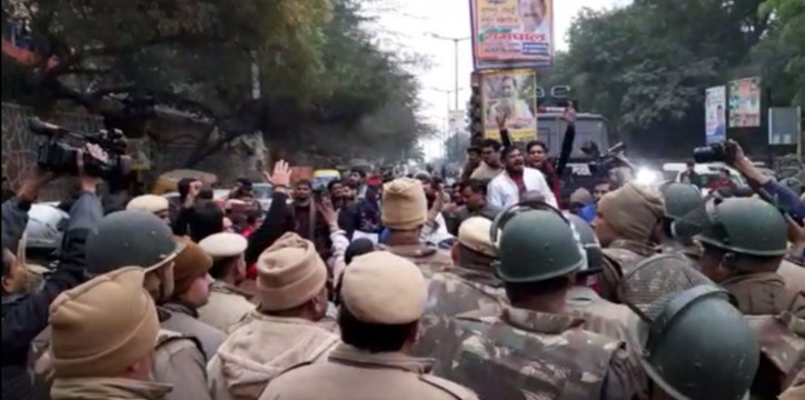 ABVP activists gather outside the JNU main gate from Munirka Village