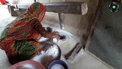 Traditional Way of Grinding Rice Flour ढिकिमा पिठो कुट्दै ।