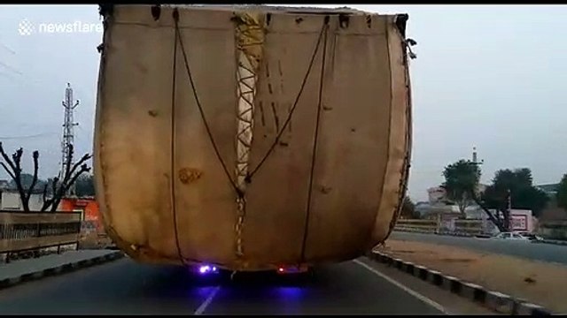 Massively overloaded tractors take up two lanes on north Indian highway