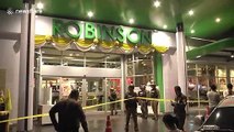 Police remove bodies after gunman kills three, including boy, during shopping mall robbery in Thailand