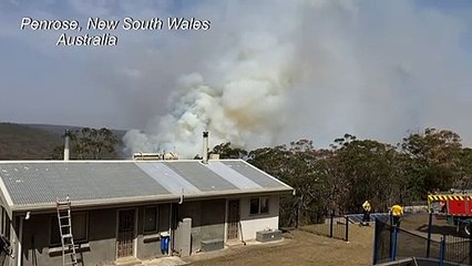 Australian firefighters battle to protect house