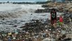Families in Indonesia search through heaps of rubbish washed up on beach for valuables