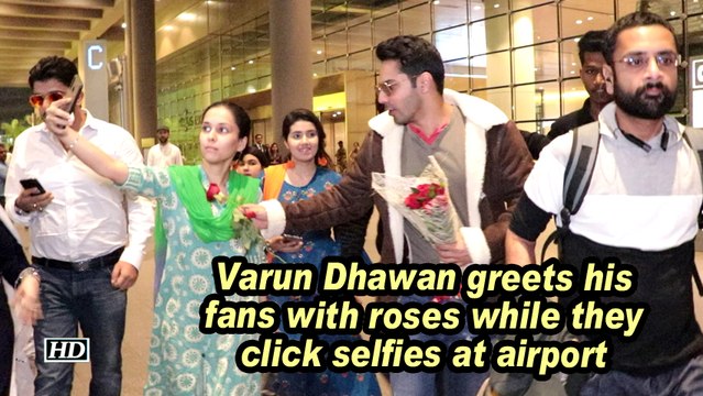 Varun Dhawan greets his fans with roses while they click selfies at airport