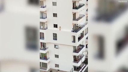 Nail-biting moment toddler walks on balcony ledge three storeys up