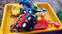 Toy tractor carries many cars for kids in the forest 