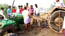 New holland and JohnDeere tractors stuck in mud