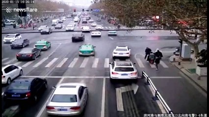 Chinese man walks along guardrails on busy road to check his blood pressure