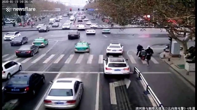 Chinese man walks along guardrails on busy road to check his blood pressure