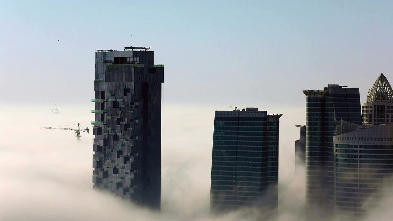 Beautiful Timelaps of Clouds Flowing Like a River Around Tall SkyScrapers