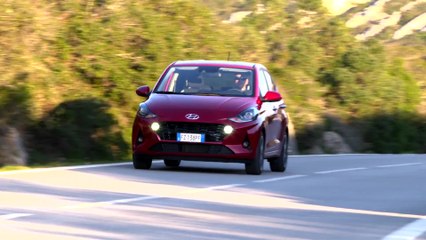 The new Hyundai i10 in Dragon Red Driving in the country