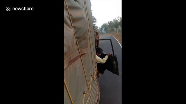 Moment driver reverses vehicle in panic as raging elephant chases him