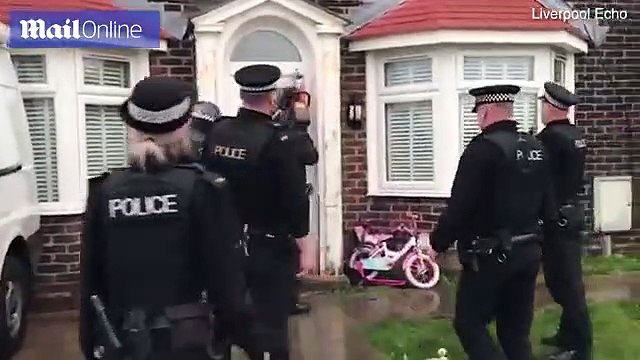 Merseyside Police officers use chainsaw to break down door in raid