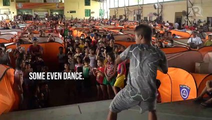 Taal Volcano wont stop Filipino evacuees from singing