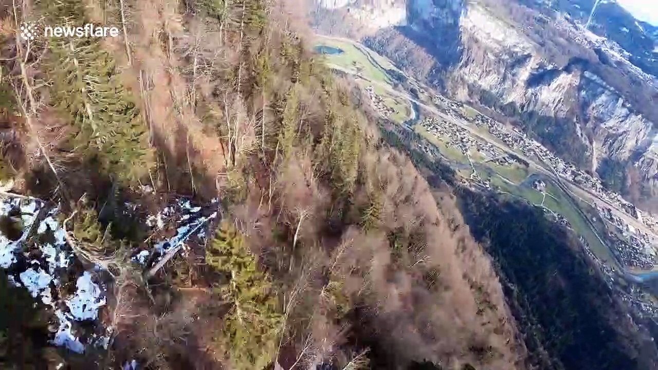French daredevil wingsuits through dense forest in the French Alps