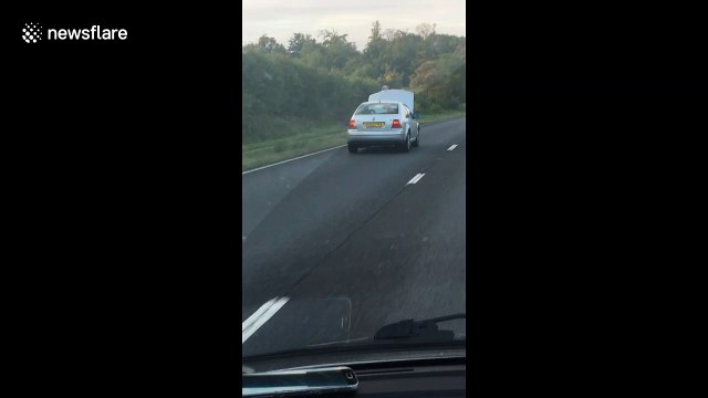 Unbelievable video shows driver cruising down highway with hood OPEN