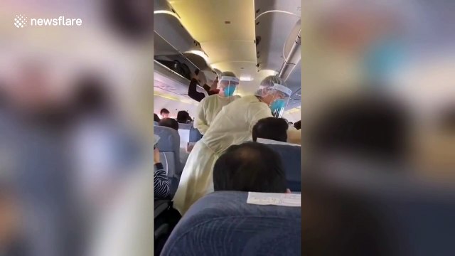 Medics on Air China plane check passengers' temperatures in bid to contain new virus