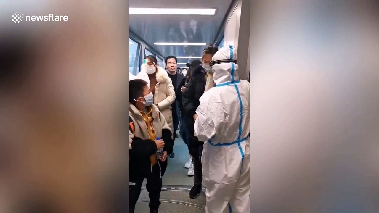 Hangzhou International Airport staff check tourists' temperatures amid coronavirus scare