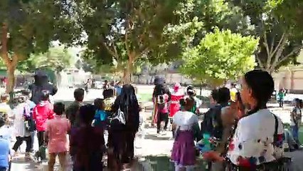 School Boys Followed Cartoon Clowns In Park