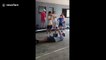 Australian science teacher performs controversial physics experiment letting student smash concrete block on his chest with sledge hammer