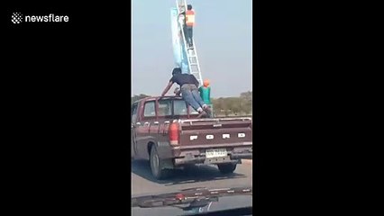 Reckless passenger does press-ups in the back of moving pickup truck in Thailand