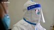 Doctors in protective clothing treat patients in Wuhan hospital during the coronavirus outbreak
