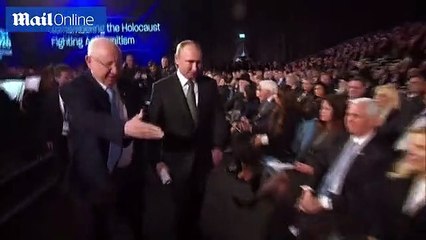 Russian President Vladimir Putin shakes hands with Prince Charles