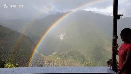 Beautiful double rainbow stretches over valley in the Philippines
