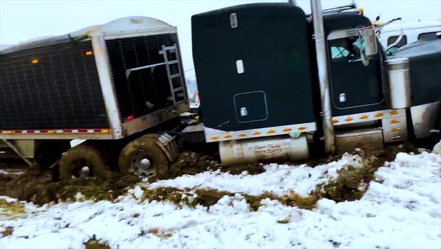 Truck slides off slick highway