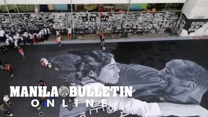 Fans of Kobe Bryant pay their respect by visiting the large mural of him with his daughter at Tenement Building in Taguig