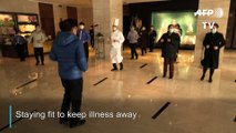 Hotel staff in Wuhan exercise daily to keep virus at bay