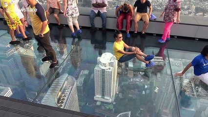 Tourists enjoy stunning view from 1,000ft high glass skywalk in Bangkok