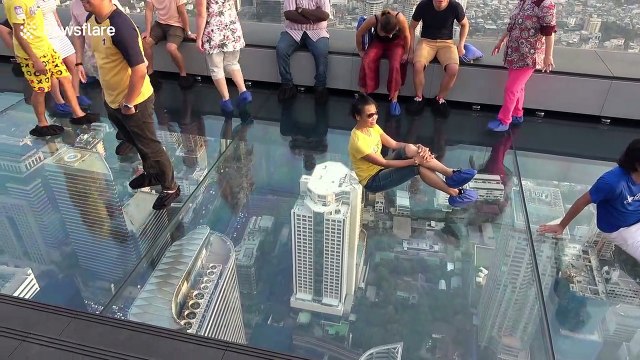 Tourists enjoy stunning view from 1,000ft high glass skywalk in Bangkok