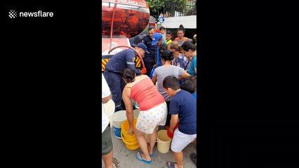 People in Colombia are aided with drinking water after a strong rainstorm