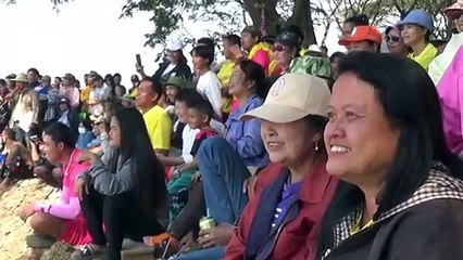 Muay Thai boxing enthusiasts fight on bamboo pole over a river