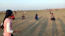 Indian Sports in the early evening in a field